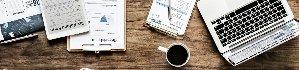 Desk with papers and laptop