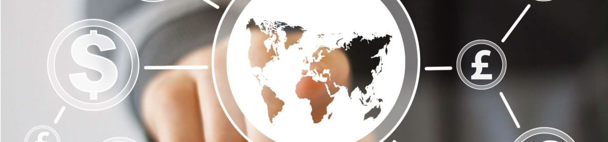 Finger pointing at glass world map