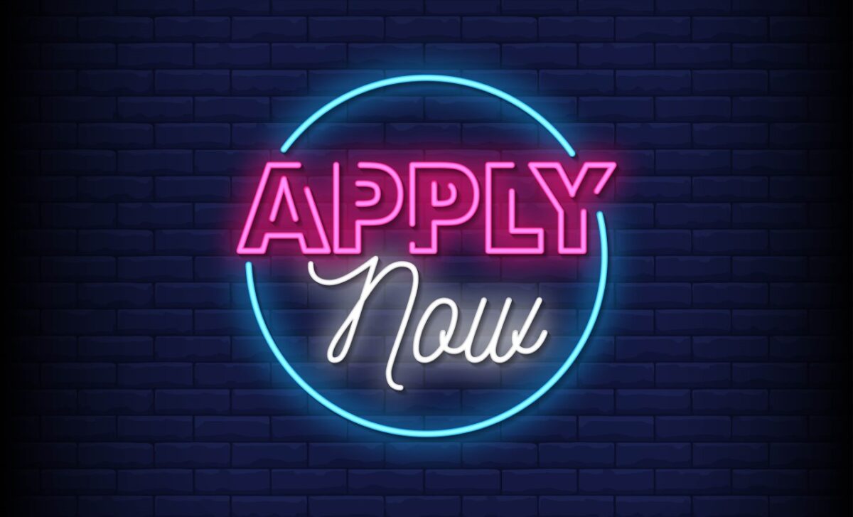 illuminated sign stating "apply now"